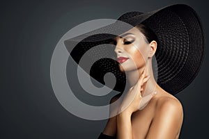 Lady in Black Hat with Red Lipstick Make up. Elegant Woman with Face Makeup and Nails Manicure over Dark Gray. Beautiful Model