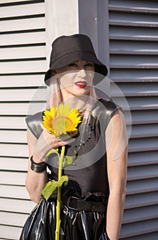 Lady in black hat with sunflower