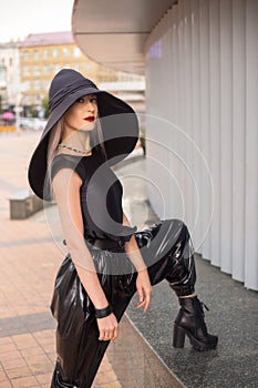 Lady in the black latex trousers and black sexy hat