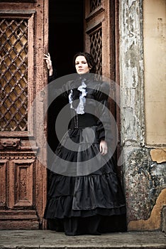 Lady in black standing in the doorway