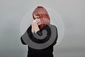 Lady in black sweater sick woman with snot in a handkerchief, cold, runny nose photo
