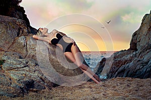 Lady in black swimsuit on seashore