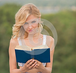 Lady with a book outdoors