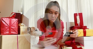 Lady buying online with credit card and smartphone home pet