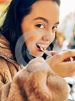 Lady in cafe tasting food on the table in Paris, France.