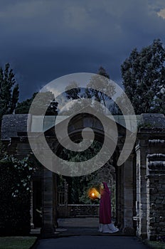 Lady in castle garden at night
