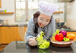 Lady chef preparing ingredient to make salad