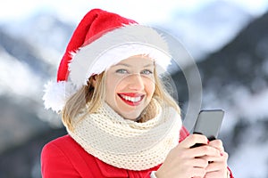 Lady on christmas holidays holding a smart phone