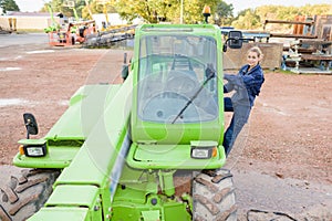 Lady climbing into telehandler