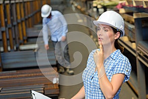 Lady with clipboard wearing hardhat photo