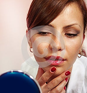 Lady with compact mirror