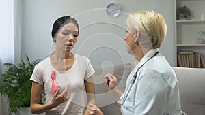 Lady consulting with mammologist, finding tumor in breast, cancer prevention