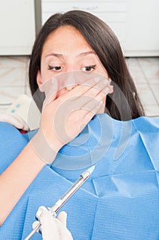 Lady in dentist chair being scared about anesthetic needle photo