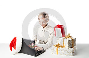 Lady at desk with present boxes and hat over white