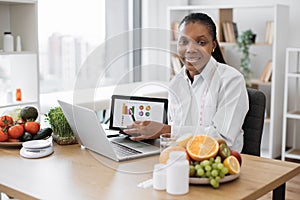 Lady with diet plan on tablet doing video conference at work