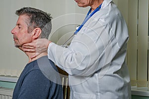 A lady doctor checks a patient's glands.