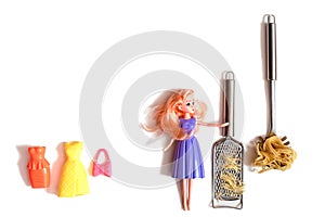 lady doll in fashionable purple clothes is cooking pasta. Raw pasta and cheese. Metal cheese grater and slotted spoon. Cooking