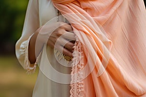 lady draping peach pashmina shawl