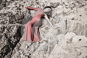 Lady in dress laying in the dirt