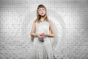 lady in dress looks into camera with disgruntled emotion, waiting with claim