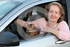 Lady driving with her feline companion