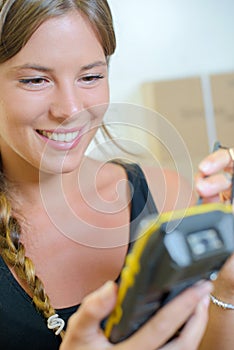 Lady electronically signing to receive parcel