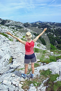 Lady expressing happiness in the mountains