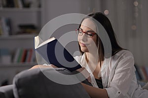 Lady with eyeglasses reads a book at home