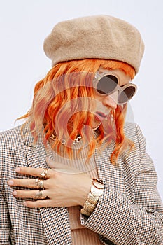 Lady in fashion elegant outfit. Trendy beige beret, sunglasses and stylish plaid blazer.  Paris Girl lookbook. Style in details