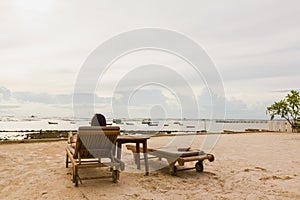 Lady feel relax on bed beach on holiday