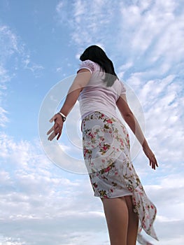 Lady feeling the wind with sky