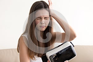 Lady feels dizziness after using VR glasses photo