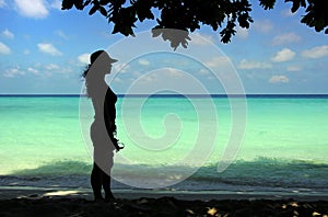 Lady figure with seascape background.