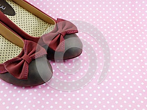 Lady flat shoes decoration with bow on pink background