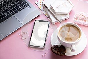 Lady freelancer's home pastel pink workplace, cup of coffee and smartphone mock-up