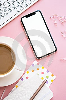 Lady freelancer's home pastel pink workplace, cup of coffee and smartphone mock-up