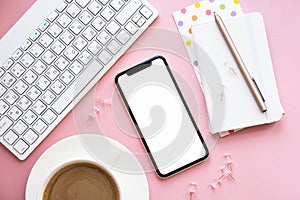 Lady freelancer's home pastel pink workplace, cup of coffee and smartphone mock-up