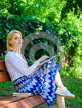 Lady freelancer working in park. Wi fi network connection free access. Woman with laptop works outdoor, green nature