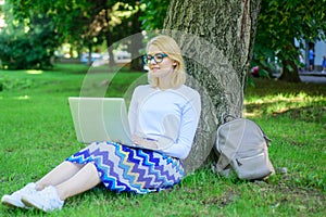 Lady freelancer working in park. Wi fi network connection free access. Woman with laptop works outdoor, park background