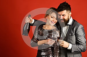 Lady and gentleman celebrating with merlot. Woman in sparkling dress