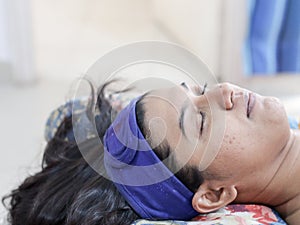 A lady getting ready for facial spa beautification cosmetic procedure with protective head band