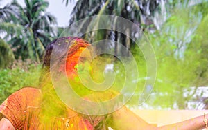 A lady getting showered with holi colours during holi festival in india