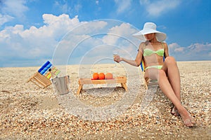 Lady with glass of champagne on beach