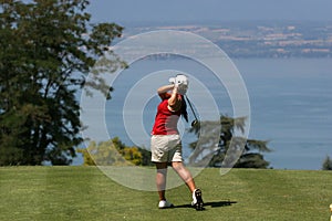 Lady golf swing at Leman lake