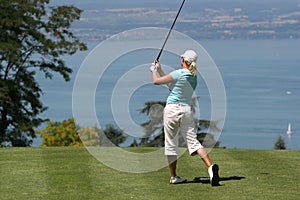 Lady golf swing at Leman lake