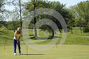 Lady Golfer On Practice Green