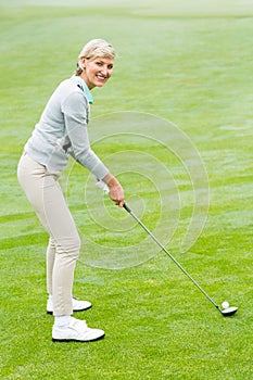 Lady golfer on the putting green