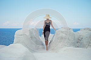 Lady in hat in an unusual landscape