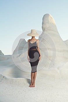 Lady in hat in an unusual landscape