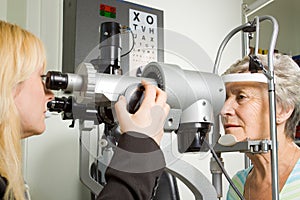 Lady having eye test examination photo